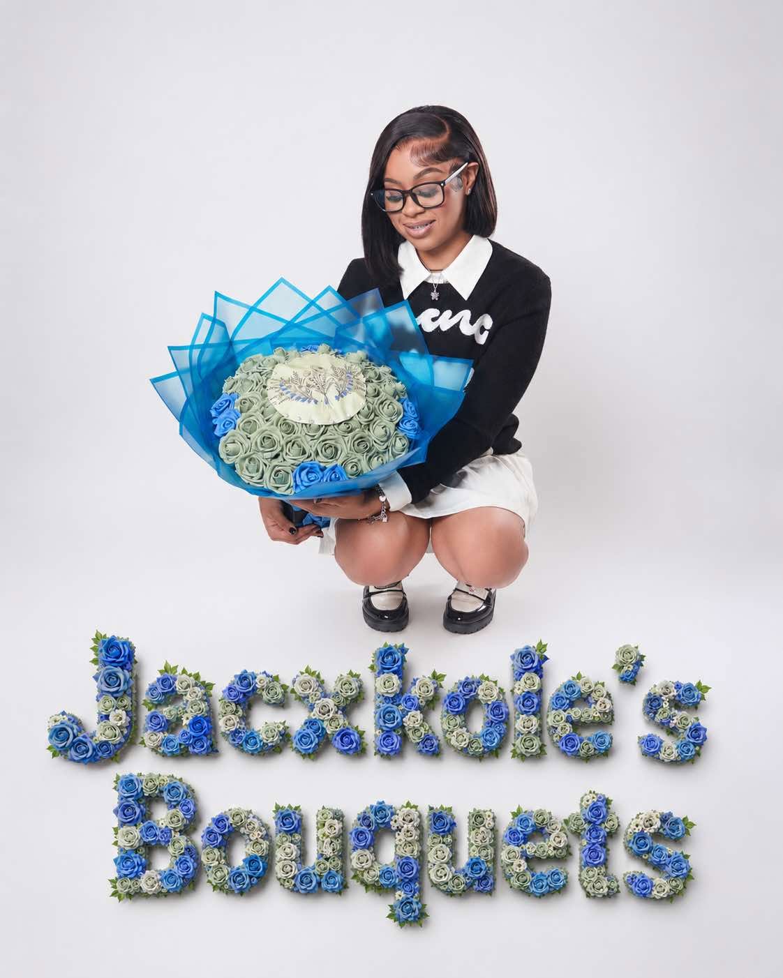 Ja'Cole Payne kneeling beside her business name spelled out in roses