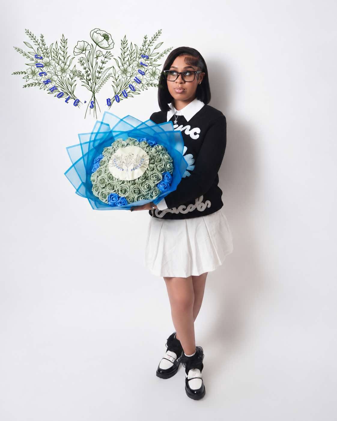Ja'Cole holding a handcrafted sage-green and blue rose bouquet with the Jacxkole's Bouquets botanical motif