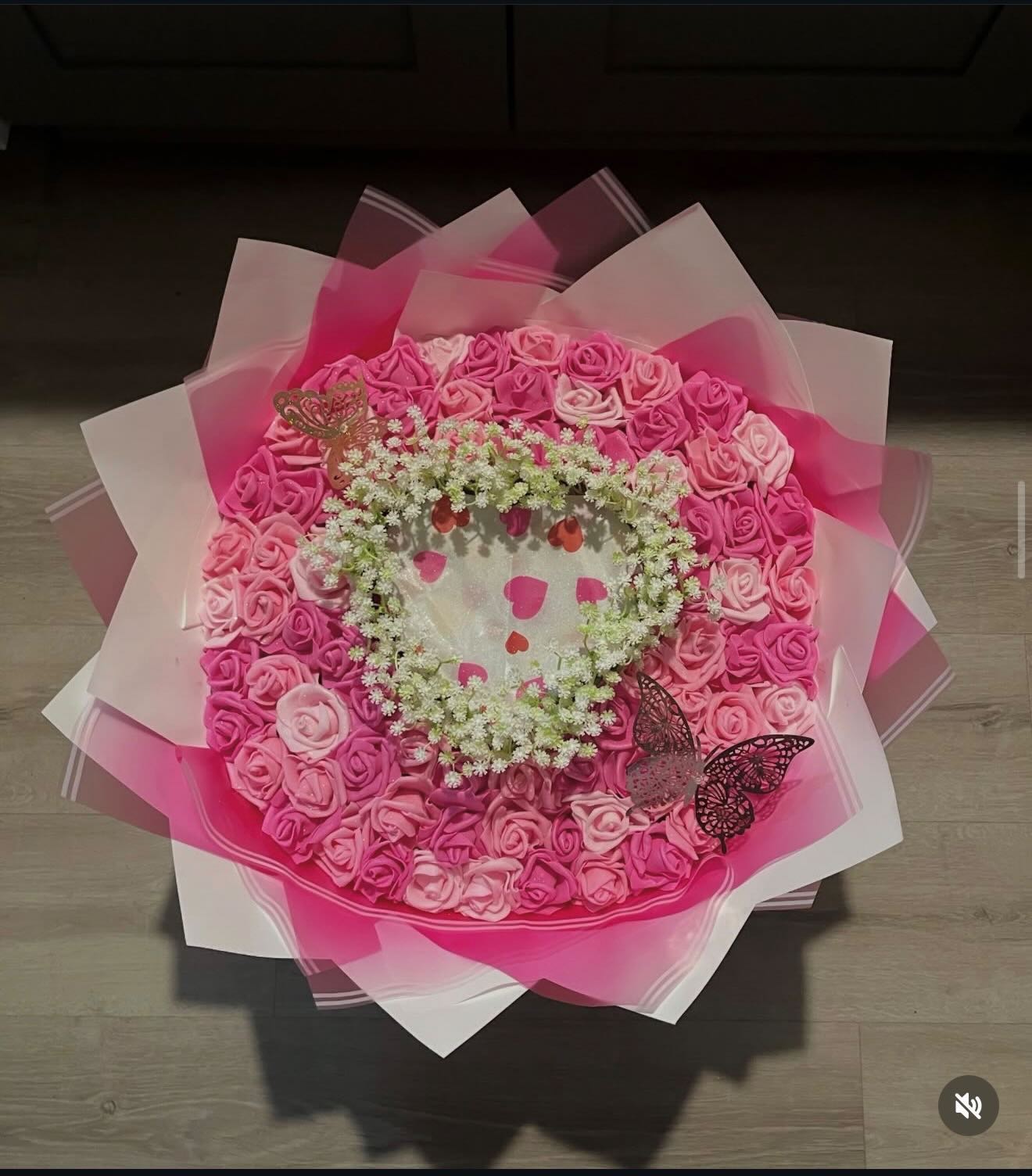 Burn bouquet of pink foam roses with a baby’s breath heart and butterfly accents