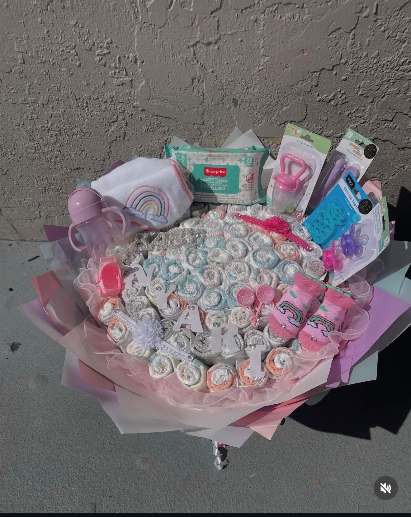 Diaper bouquet with baby essentials spelling a baby’s name